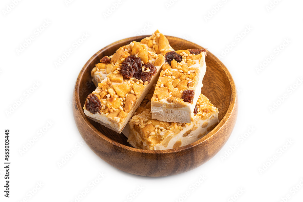 Traditional candy nougat with nuts and sesame isolated on white, side view. Traditional candy nougat with nuts and sesame isolated on white, side view.