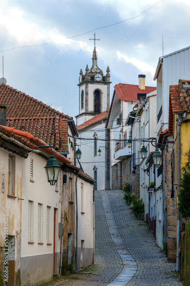 Obraz premium european city alleyway street receding towrds distant church