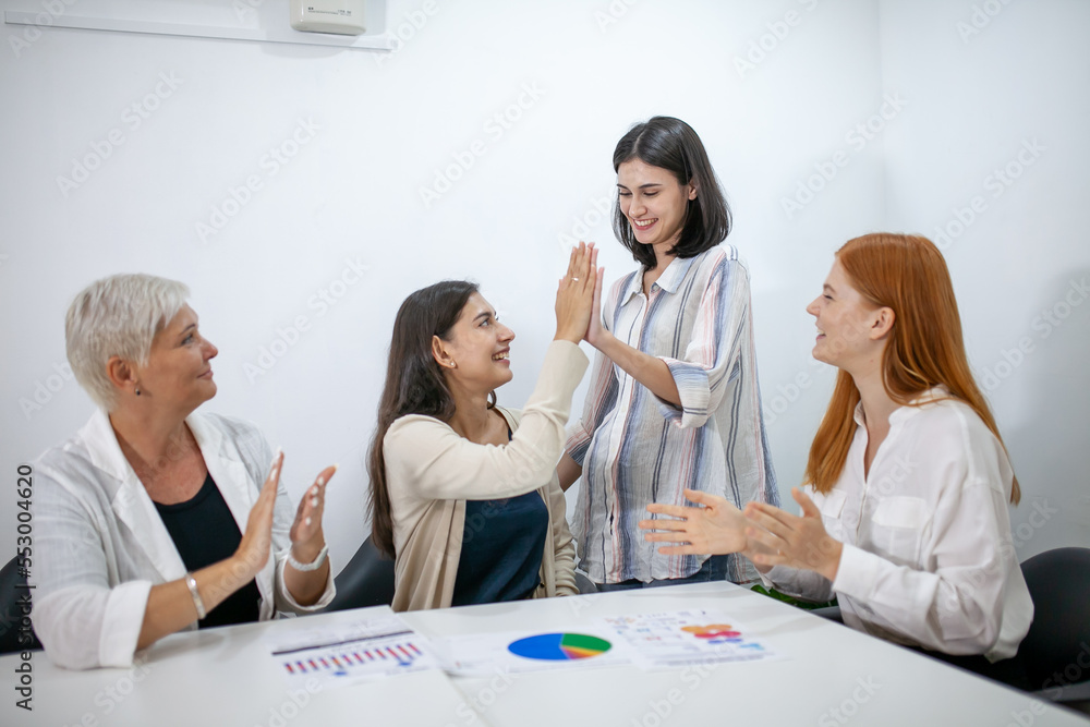 Business team colleagues talking at work share ideas with data report in hands, Happy colleagues work together in office, CEO executive in corporate office. Business team colleagues talking at work share ideas with data report in hands, Happy colleagues work together in office, CEO executive in corporate office.