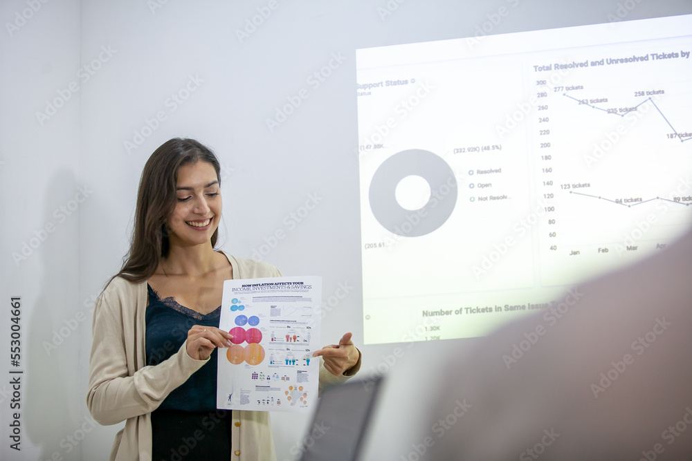 Obraz premium business team colleagues talking at work share ideas with chart on board, Happy businesswoman presentation colleagues work together on board.