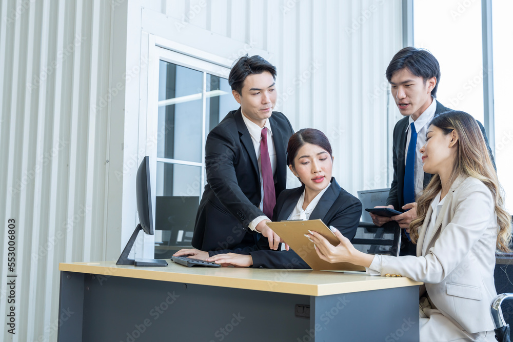 A group of young Asian businessmen Talking and planning work happily and have fun. at the company's office A group of young Asian businessmen Talking and planning work happily and have fun. at the company's office
