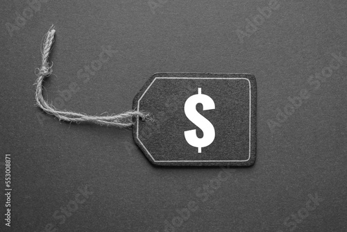 black price tag with dollar sign on the black background, black mockup photo