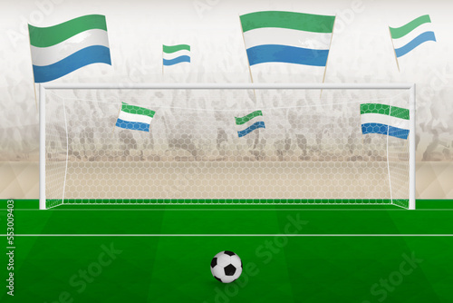 Sierra Leone football team fans with flags of Sierra Leone cheering on stadium, penalty kick concept in a soccer match.