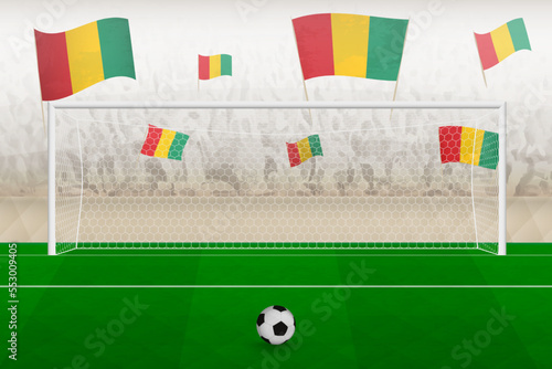 Guinea football team fans with flags of Guinea cheering on stadium, penalty kick concept in a soccer match.