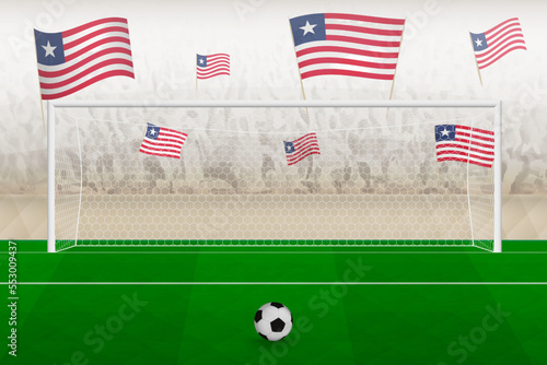 Liberia football team fans with flags of Liberia cheering on stadium, penalty kick concept in a soccer match.