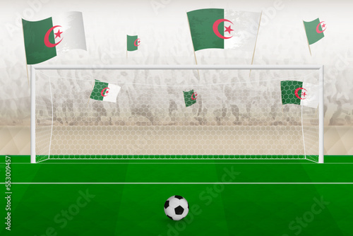 Algeria football team fans with flags of Algeria cheering on stadium, penalty kick concept in a soccer match.