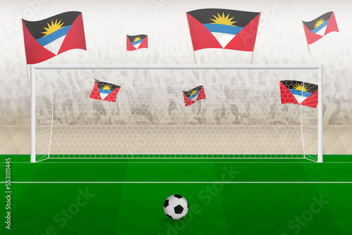 Antigua and Barbuda football team fans with flags of Antigua and Barbuda cheering on stadium, penalty kick concept in a soccer match.