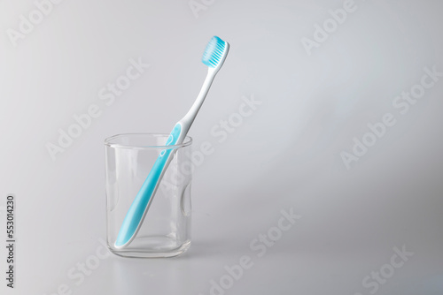 Toothbrush in a glass  personal care product  on white background.
