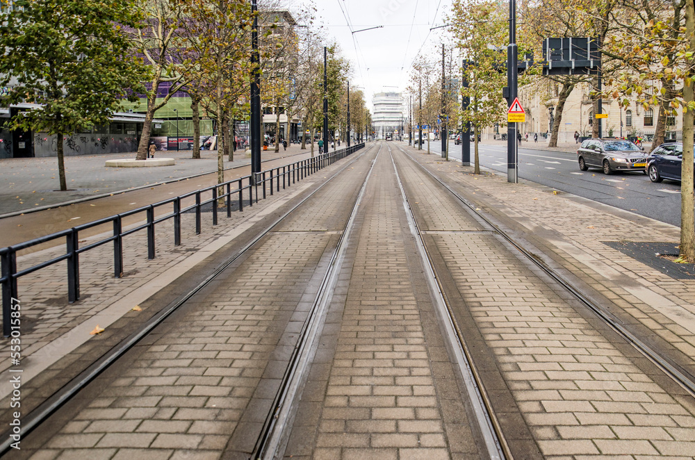 Rotterdam, The Netherlands, November 23, 2022: tramtracks on refurbished Coolsingel boulevard, paved with concrete tiles in spite of green ambitions