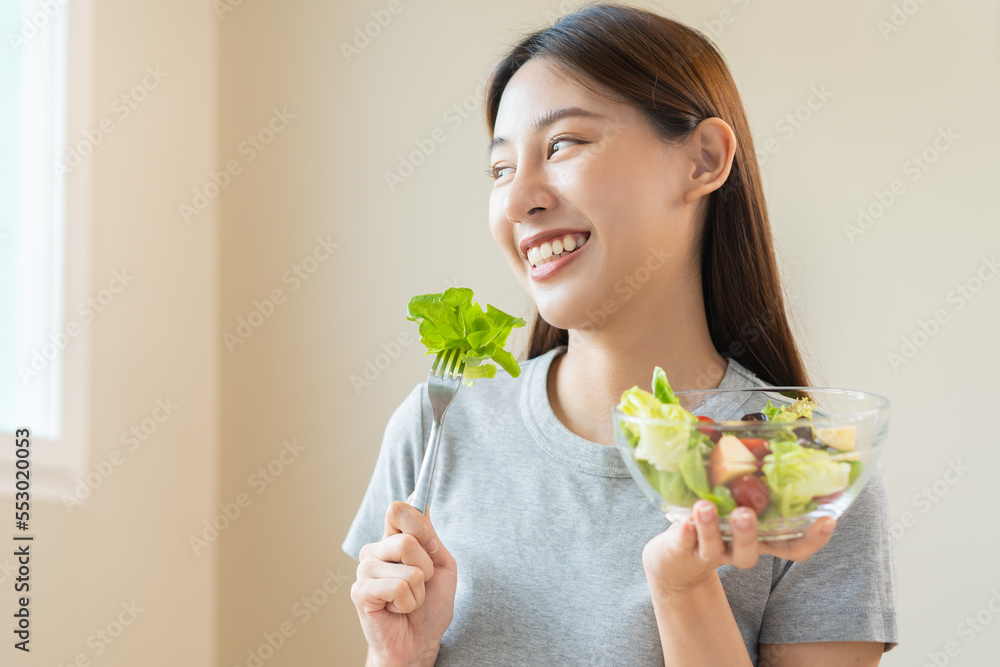 Diet, Dieting asian young woman or girl use fork at lettuce on mix vegetables, green salad bowl, eat food is low fat good health. Nutritionist female, Weight loss for healthy person. Diet, Dieting asian young woman or girl use fork at lettuce on mix vegetables, green salad bowl, eat food is low fat good health. Nutritionist female, Weight loss for healthy person.