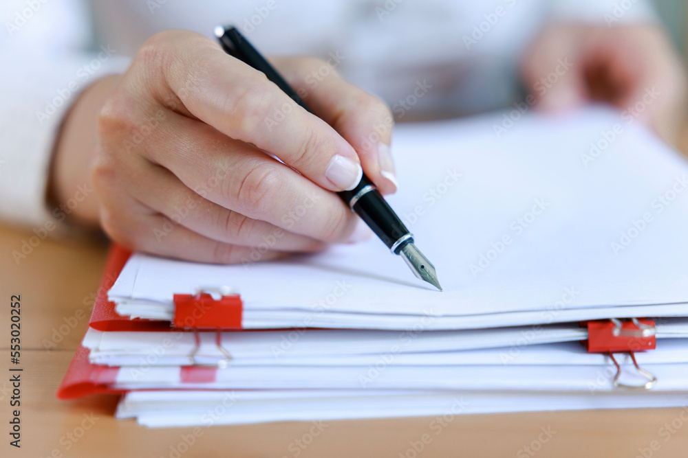 Auditor business woman checking documents, issuing report for legal preparation. Organizes accounting data. Auditor business woman checking documents, issuing report for legal preparation. Organizes accounting data.