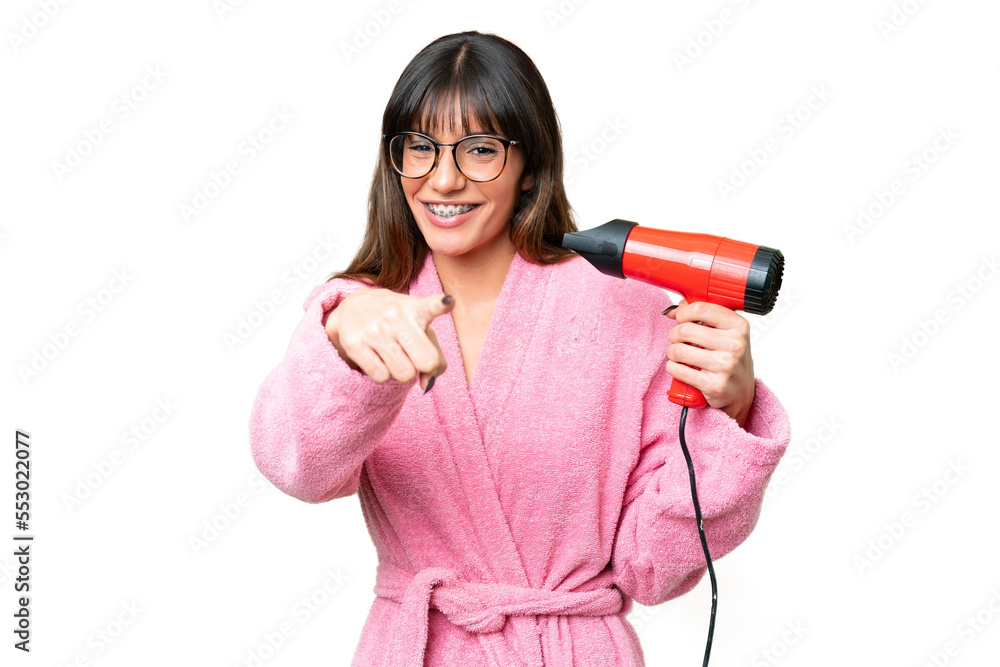 Young caucasian man holding a hairdryer over isolated chroma key background points finger at you with a confident expression Young caucasian man holding a hairdryer over isolated chroma key background points finger at you with a confident expression