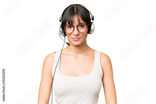 Telemarketer caucasian woman working with a headset over isolated background laughing