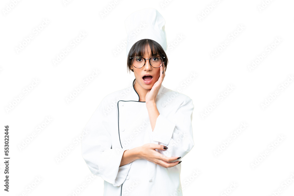 Young caucasian chef woman over isolated chroma key background surprised and shocked while looking right Young caucasian chef woman over isolated chroma key background surprised and shocked while looking right