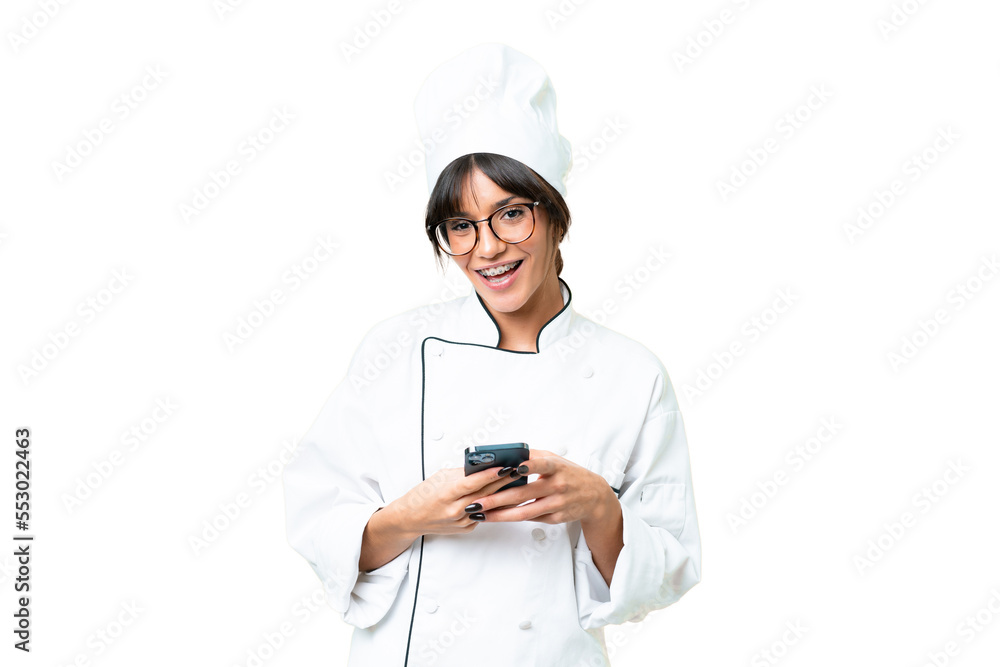 Young caucasian chef woman over isolated chroma key background surprised and sending a message Young caucasian chef woman over isolated chroma key background surprised and sending a message