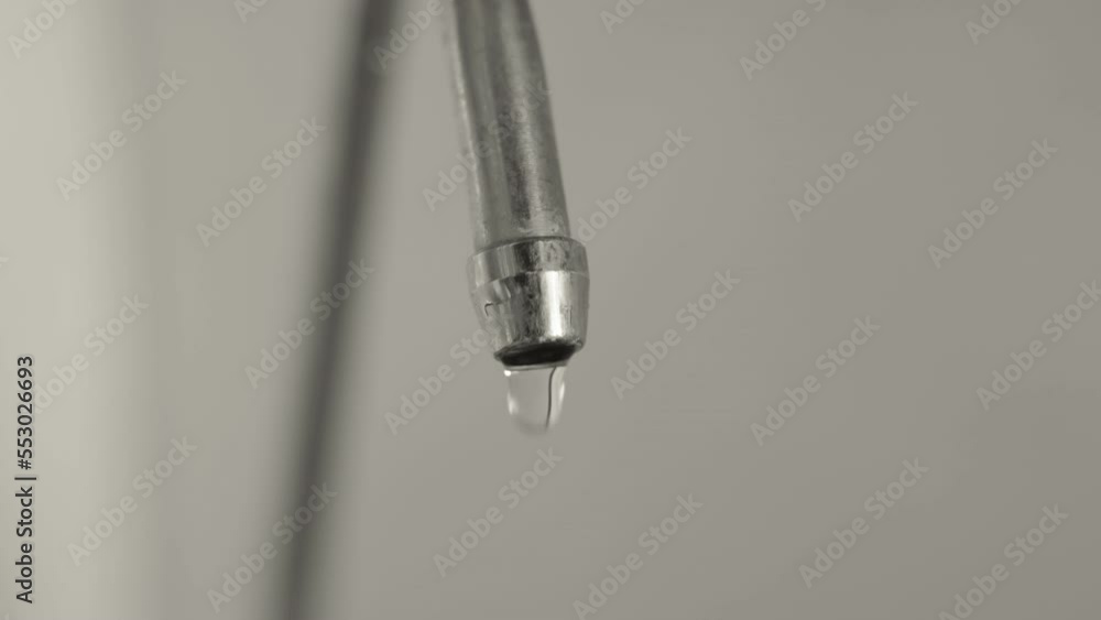 Close-up, drinking water dripping from a broken kitchen faucet