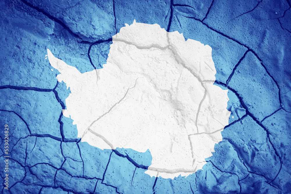 Flag of Antarctica. Antarctica symbol. Flag on the background of dry cracked earth. Antarctica flag with drought concept