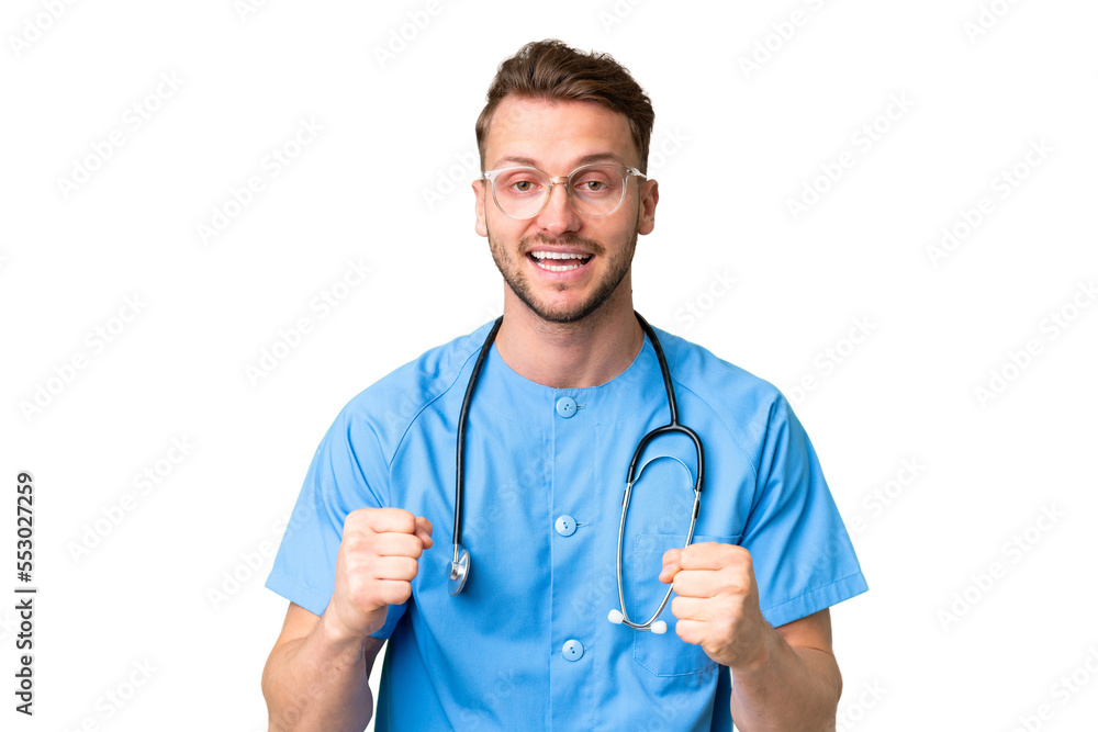 Young nurse man over isolated chroma key background celebrating a victory in winner position Young nurse man over isolated chroma key background celebrating a victory in winner position