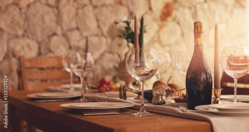 Valokuva Dinner wood table in outdoor garden with vine glass and boatle, sun light banner