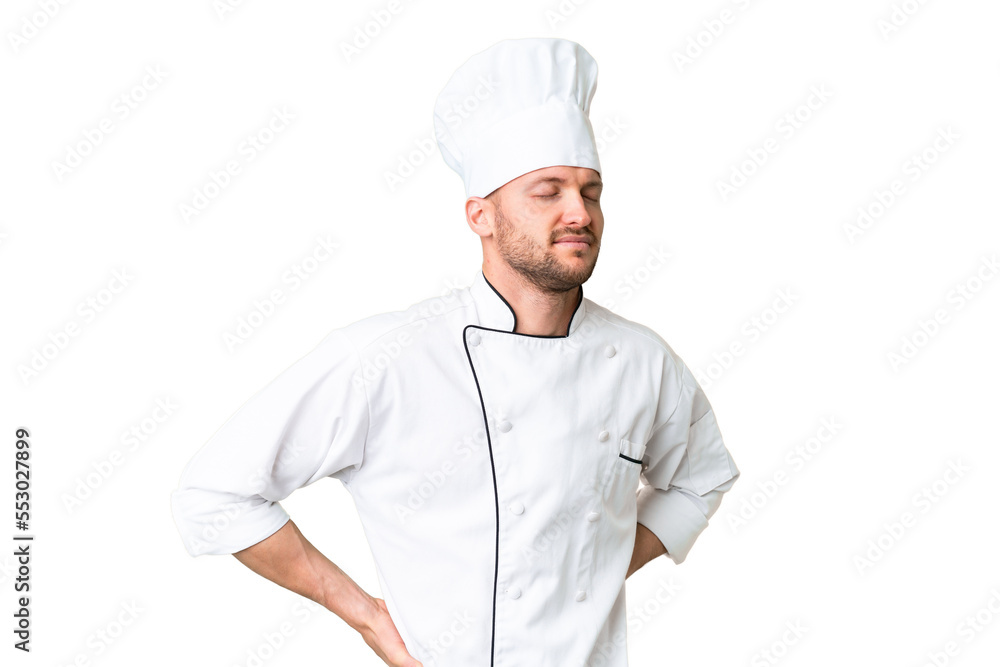 Young caucasian chef over isolated chroma key background suffering from backache for having made an effort Young caucasian chef over isolated chroma key background suffering from backache for having made an effort