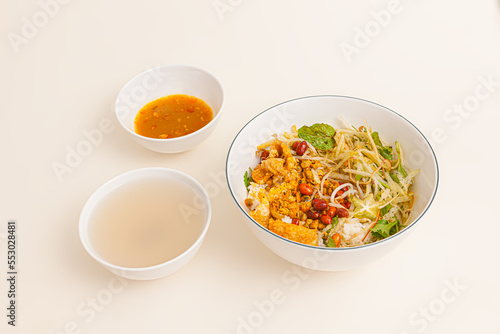 Com hen, Vietnamese rice dish with baby basket clams rice, Vietnamese food isolated on white background, perspective view