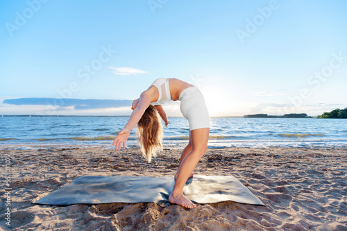 Obraz na płótnie young woman practicing yoga exercises .Standing backbend. Backbe w salonie