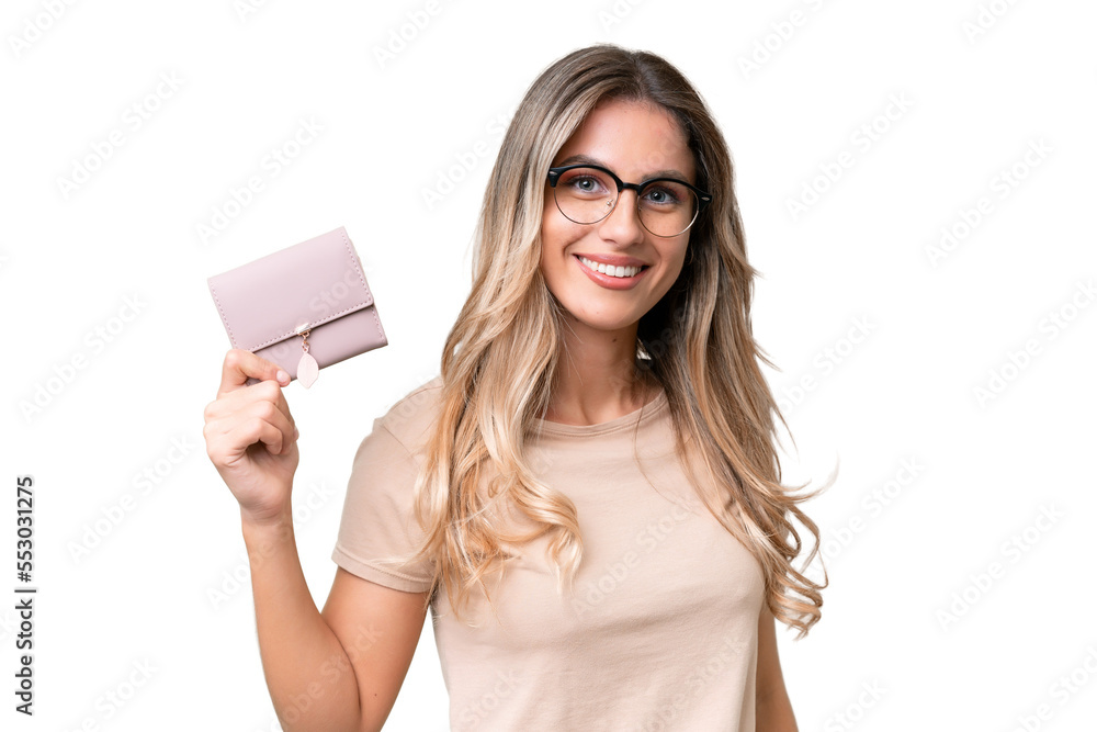 Young Uruguayan woman holding a wallet over isolated background smiling a lot Young Uruguayan woman holding a wallet over isolated background smiling a lot