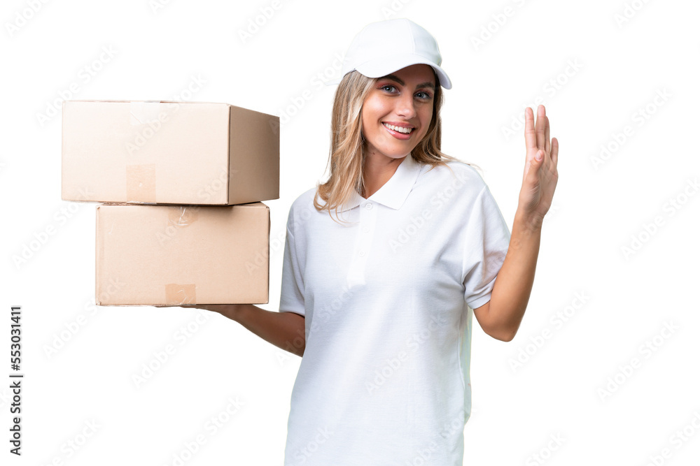 Delivery Uruguayan woman over isolated background saluting with hand with happy expression Delivery Uruguayan woman over isolated background saluting with hand with happy expression