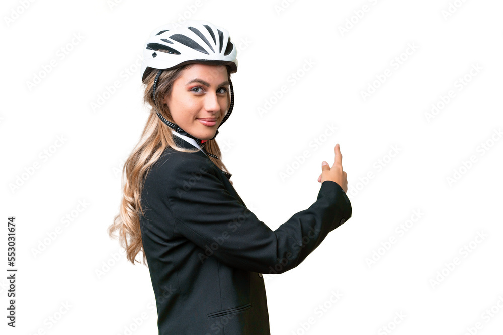 Business Uruguayan woman wearing a helmet biker over isolated background pointing back Business Uruguayan woman wearing a helmet biker over isolated background pointing back