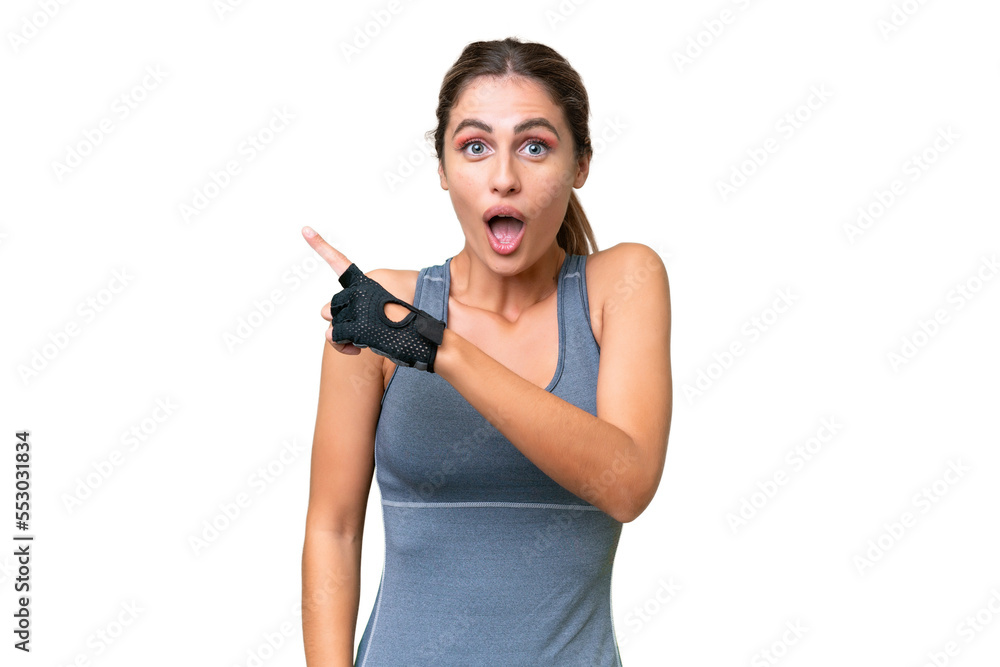 pretty Sport Uruguayan woman over isolated background surprised and pointing side pretty Sport Uruguayan woman over isolated background surprised and pointing side