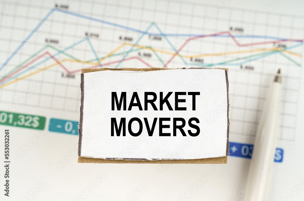 Naklejka premium Against the background of business graphics and pens, a sign with the inscription - Market Movers