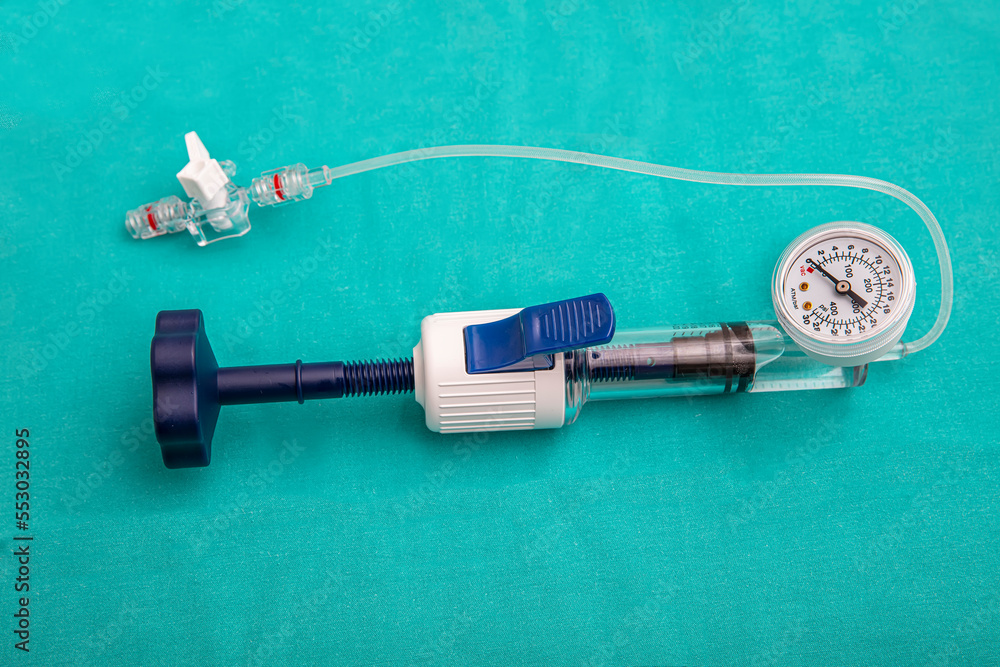 A balloon inflation device used in angioplasty procedure. Mesh metal