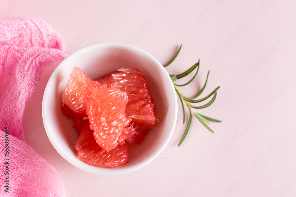 Peeled pieces of grapefruit and rosemary in a bowl. Cocktail ingredients. Top view. Closeup