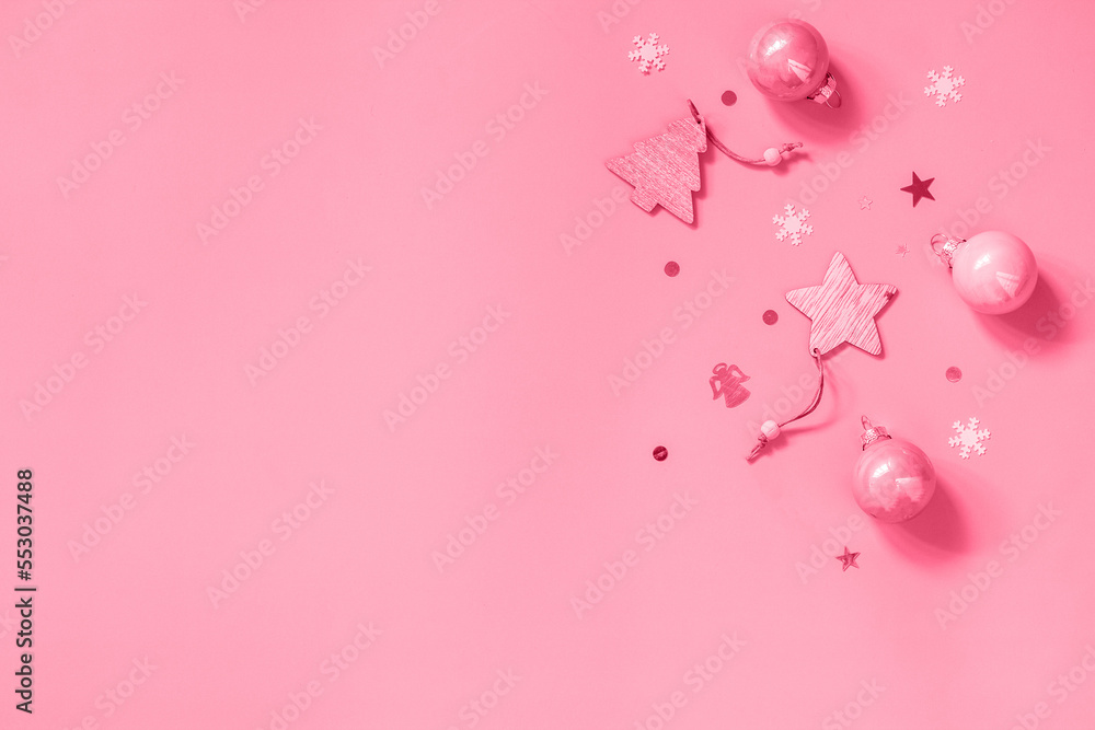 Christmas composition. Sail Champagne decorations with ball on pink background. Flat top view. Copy space. Trendy color of year 2023 - Viva Magenta.