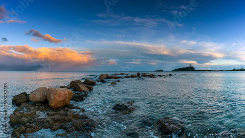 sunset at Nora Beach in Sardinia with the Coltellazzo Tower in the background