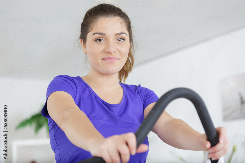 portrait of young women exercising on machines in the gym