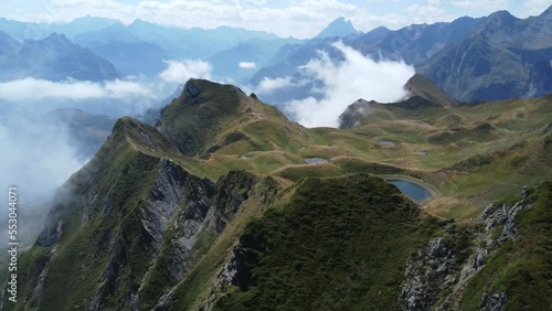 Couple contemplates from above the Lac de Montagnon D'Iseye. Ossau Valley. French Pyrenees