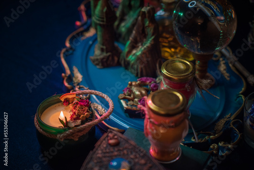 Fortune-telling cards and burning candles on a table on mystic background 