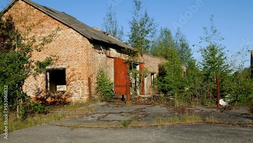 A farm building in the buried radioactive village of Kopachi.  Cemetery of agricultural machinery in Chernobyl. Chernobyl Exclusion Zone. Ukraine. photo