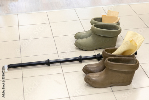 Rubber boots and an electric rod for working under voltage. Protection of people from electric shock.
