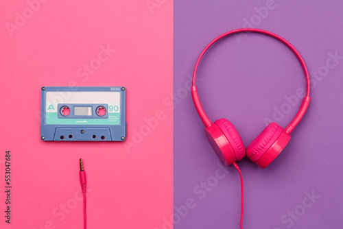A-side of blue audio cassette on a pink background and pink headphones on a purple background.