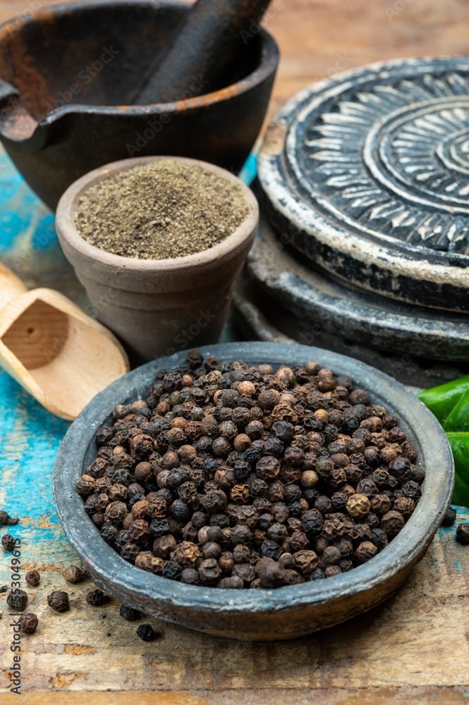 Indian spices collection, dried black peppercorns and another spices in clay bowls Indian spices collection, dried black peppercorns and another spices in clay bowls