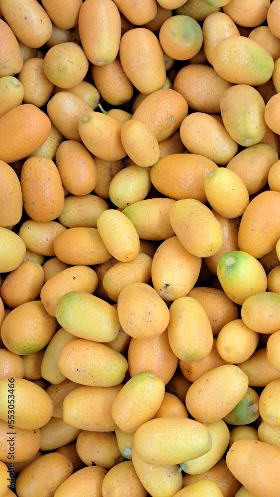 Ripe kumquat. Located throughout the frame. Top view. Background. Texture. Copy space Ripe kumquat. Located throughout the frame. Top view. Background. Texture. Copy space