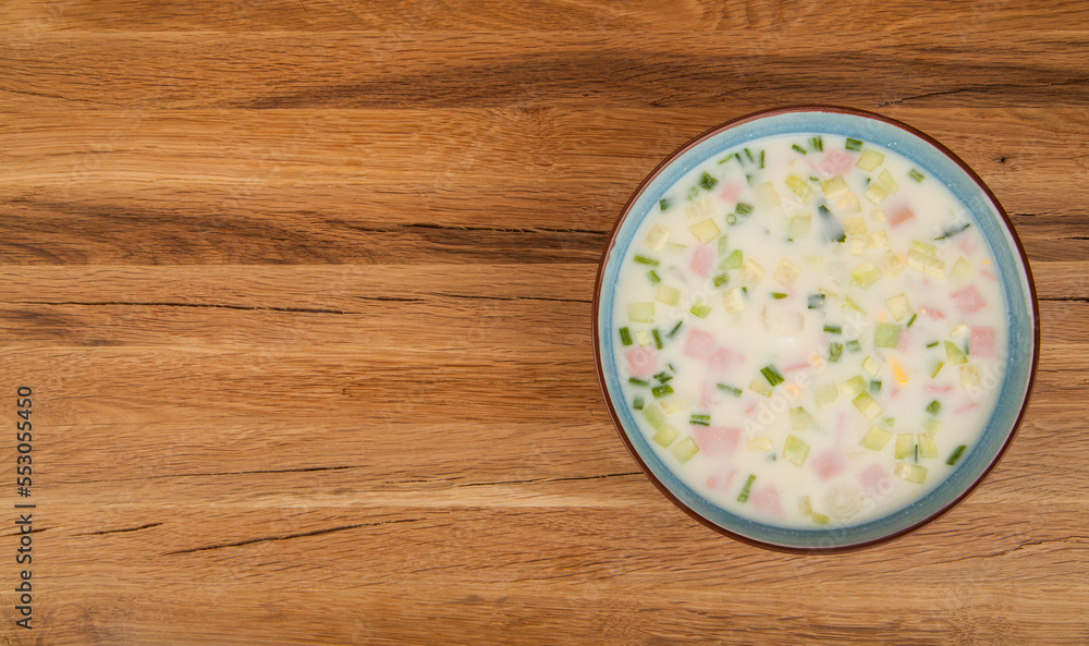 A plate of okroshka on a wooden background. A plate of okroshka on a wooden background.