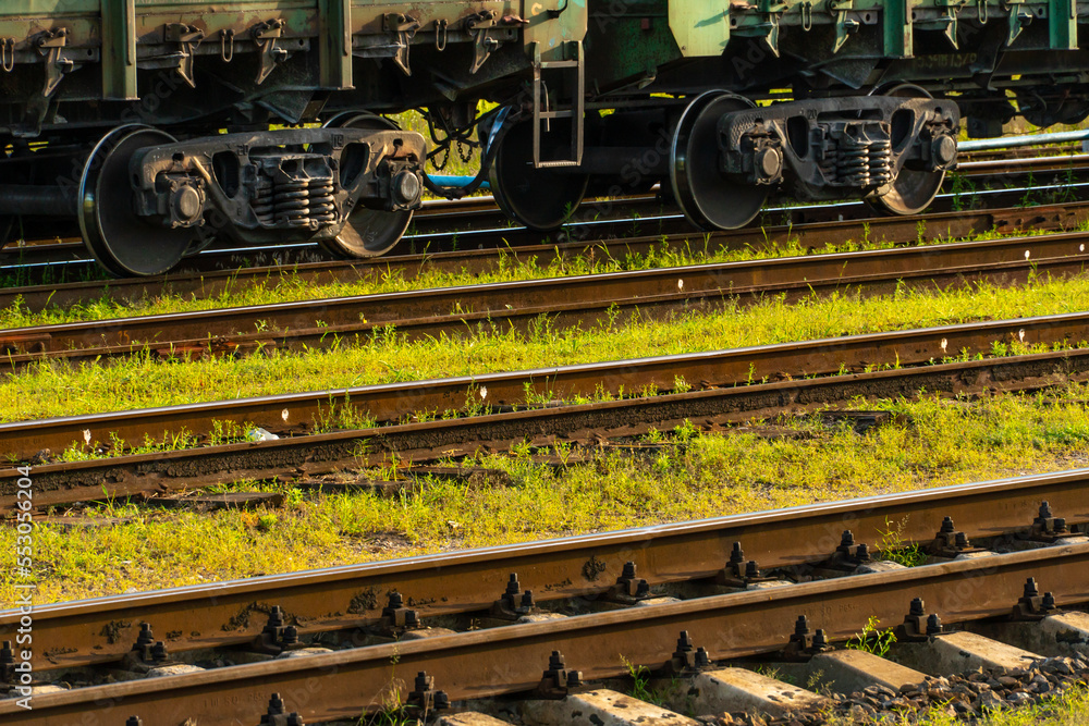 Cargo transportation by rail. There is a transport train with containers on the railway track. Logistics, transportation of essential goods, grain, fuel, industrial goods. Cargo transportation by rail. There is a transport train with containers on the railway track. Logistics, transportation of essential goods, grain, fuel, industrial goods.