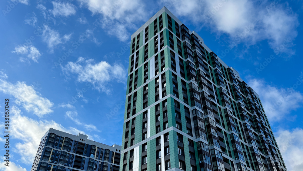 Facade of the building in green and lettuce colors, geometric patterns from windows and balconies, colored wall of a modern multistory apartment building, abstract texture of the house facade Facade of the building in green and lettuce colors, geometric patterns from windows and balconies, colored wall of a modern multistory apartment building, abstract texture of the house facade