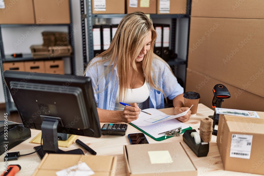 Young blonde woman ecommerce business worker working at office Young blonde woman ecommerce business worker working at office