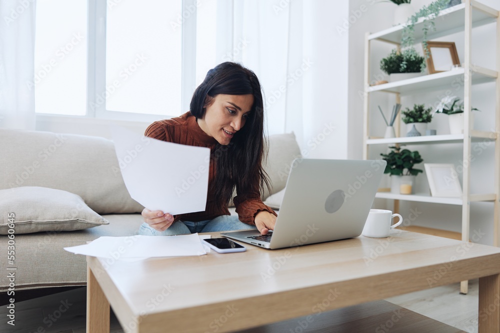 Smile woman working from home on laptop, freelance work online with documents Smile woman working from home on laptop, freelance work online with documents