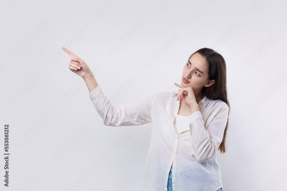 Happy young caucasian female in a shirt pointing fingers away Happy young caucasian female in a shirt pointing fingers away