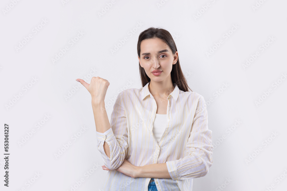 Happy young caucasian female in a shirt pointing fingers away Happy young caucasian female in a shirt pointing fingers away